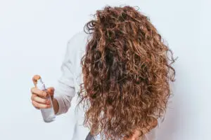 woman spraying curly hair