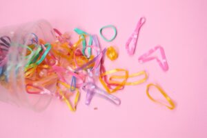 rubber bands falling out of packet on pink background