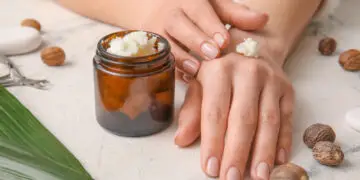 woman applying shea butter to hand