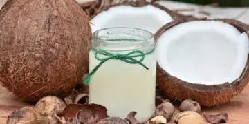 coconut oil in jar next to coconuts