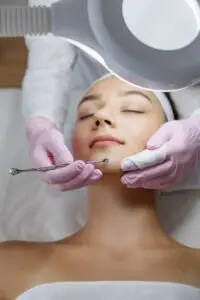 Woman Using Tool to Give Facial